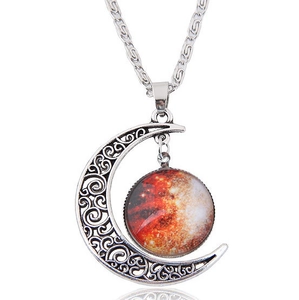 Macro detail of retro hollow crescent moon necklace with a red starry sky glass pendant