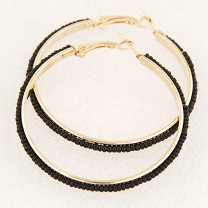 Classic gold hoop earrings with black beaded trim on a clean white background