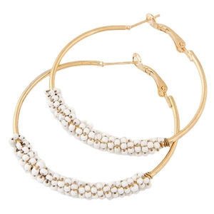 Large gold hoop earrings with white seed beads wrap design on minimalist metal rings