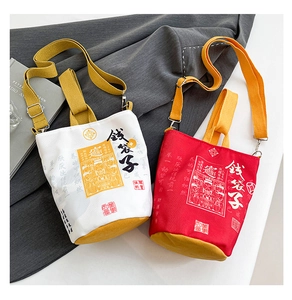 Detail view of red and white New Year money bag canvas bucket bags with yellow straps