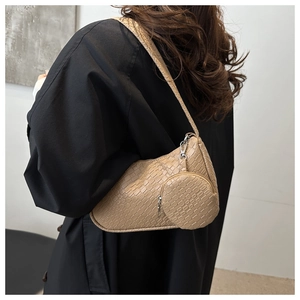 Detail of beige woven texture shoulder bag featuring a matching round coin purse pouch