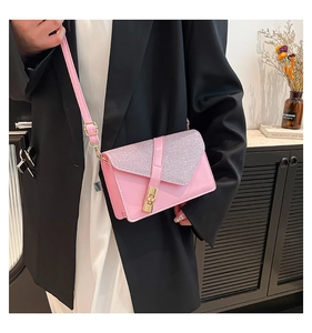 Pink glitter flap crossbody bag detail with gold metal twist lock and PU leather texture