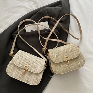 Woven crossbody bag with floral embroidery and gold metal clasp in cream and khaki