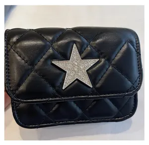 Detail of mini quilted black leather bag with sparkling star rhinestone embellishment