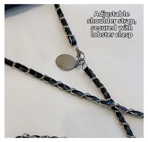 Close-up of adjustable black leather and silver chain shoulder strap with lobster clasp