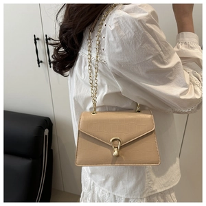 Close-up of milk tea crocodile pattern crossbody bag with a gold irregular metal buckle