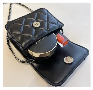 Close-up of black quilted mini bag showing spacious interior for cushion and lipstick