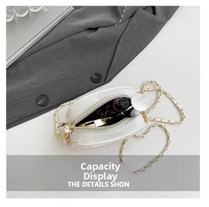 Detailed interior capacity view of white quilted mini bag with lipstick and gold chain