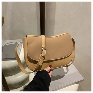 Detail of camel saddle crossbody bag in matte PU leather with decorative buckle strap
