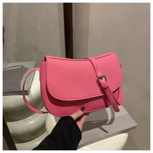 Detail of rose pink matte PU shoulder bag featuring an elegant curved flap and silver buckle