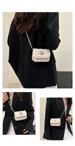 Detail of white quilted mini bag with star metal buckle and chain shoulder strap