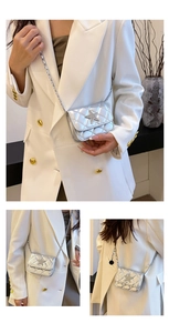 Detail of silver mini quilted crossbody bag featuring star-shaped stitching and chain strap