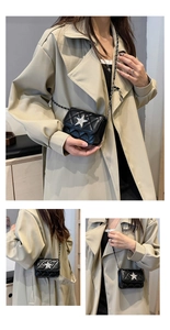 Detail view of mini black quilted crossbody bag with silver glitter star and chain strap