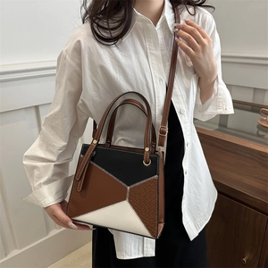 Mini geometric patchwork handbag with brown, black and white panels and shoulder strap