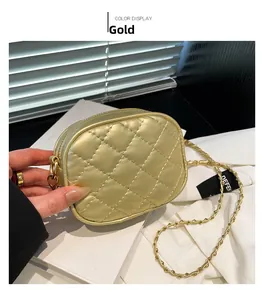 Detail of gold quilted chain bag showing classic diamond embroidery and metallic strap