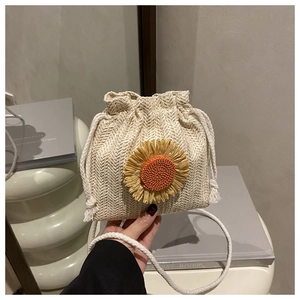Detail of hand-woven bucket bag featuring a sunflower decor and drawstring closure