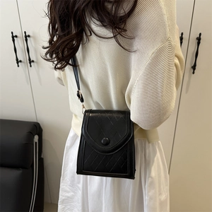 Minimalist black quilted crossbody phone bag for women with flap and round matte buckle