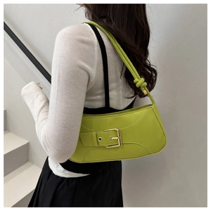 Grass green crescent underarm bag with metal buckle detail and thin strap on model
