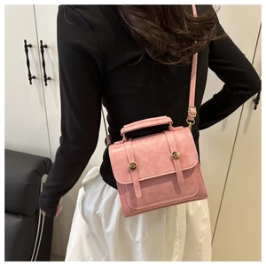Détail du mini sac carré rétro rose avec lanières en cuir et clous métalliques dorés