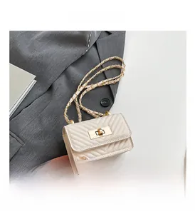 Detail of cream V-quilted mini crossbody bag with golden twist lock and chain strap