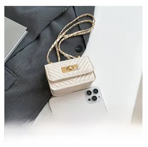 Mini quilted chain shoulder bag in beige shown next to an iPhone for size comparison