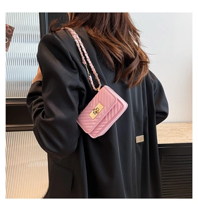 Detailed back view of pink quilted crossbody bag with chain strap and gold hardware