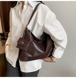 Detail of dark brown matte tote bag with shoulder strap and matching mini coin purse
