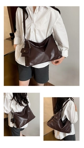 Detail of soft leather tote bag with unique mini flap charm and natural folded texture