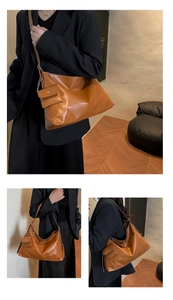 Detail shot of caramel brown soft leather tote bag with a small detachable coin purse charm