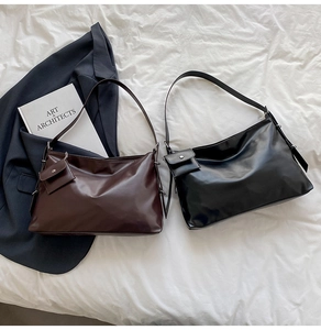 Detail of soft leather tote bags in dark coffee and black colors with a mini pouch