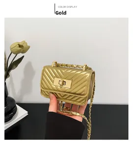 Close-up of gold quilted mini square bag with metallic chain and twist-lock closure