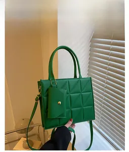 Detail of green quilted handbag with matching mini coin purse and adjustable strap