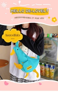 Detail of blue duck-shaped canvas crossbody bag with yellow beak and 3D feet features