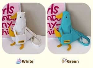 Detail of cute duck canvas crossbody bags in white and green with fashion pocket