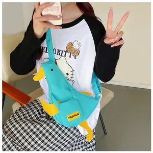 Detail of cute duck-shaped canvas chest bag with adjustable strap and front pocket