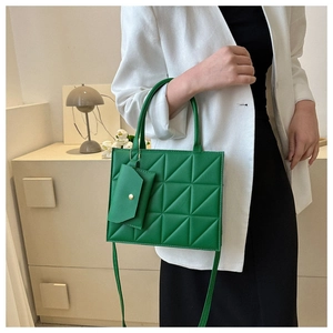 Green quilted handbag with matching coin purse and adjustable strap for women
