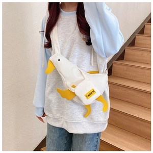 Detail showing the white canvas duck bag with yellow beak and Fashion patch on the strap