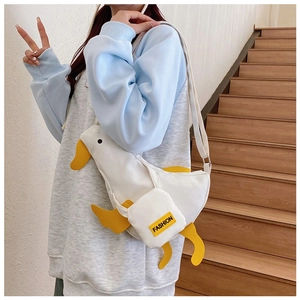 Detail of cute white duck canvas crossbody bag featuring yellow beak and fashion pocket