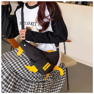 Unique black canvas bird-shaped crossbody bag with yellow duck feet decor and fashion tag