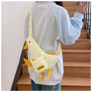 Detail view of the yellow canvas duck chest bag with fashion label and adjustable strap