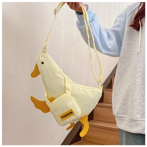 Detail showing creative yellow duck canvas crossbody bag with FASHION letter pocket
