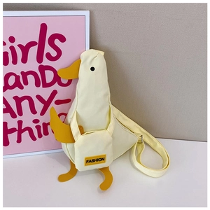Detail of cute duck-shaped canvas crossbody bag with yellow beak and FASHION label