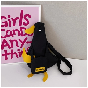 Detail view of the black canvas duck-shaped crossbody bag with adjustable strap