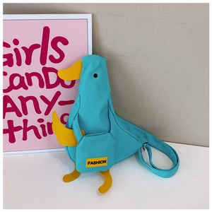 Detail of blue duck canvas crossbody bag with yellow beak and fashion tag on front