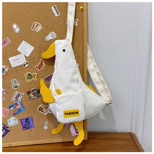 Detail view of cute 3D duck canvas bag with yellow beak and fashion label tag