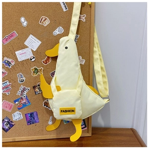 Detail of cute yellow duck canvas crossbody bag with adjustable strap and Fashion label