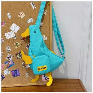Detail of cute green canvas duck crossbody bag with yellow accents and adjustable strap