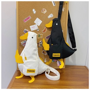 Detailed view of creative canvas duck bags in black and white with adjustable straps