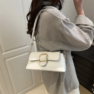 Minimalist white leather underarm bag with gold D-buckle shown on a female model