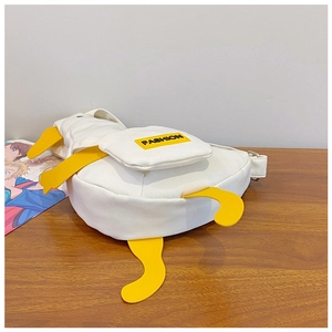 Detail showing white canvas duck crossbody bag with yellow 3D wings and FASHION label